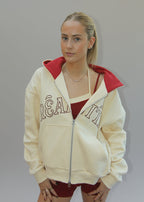 Person wearing a cream-colored hoodie with text on a white background