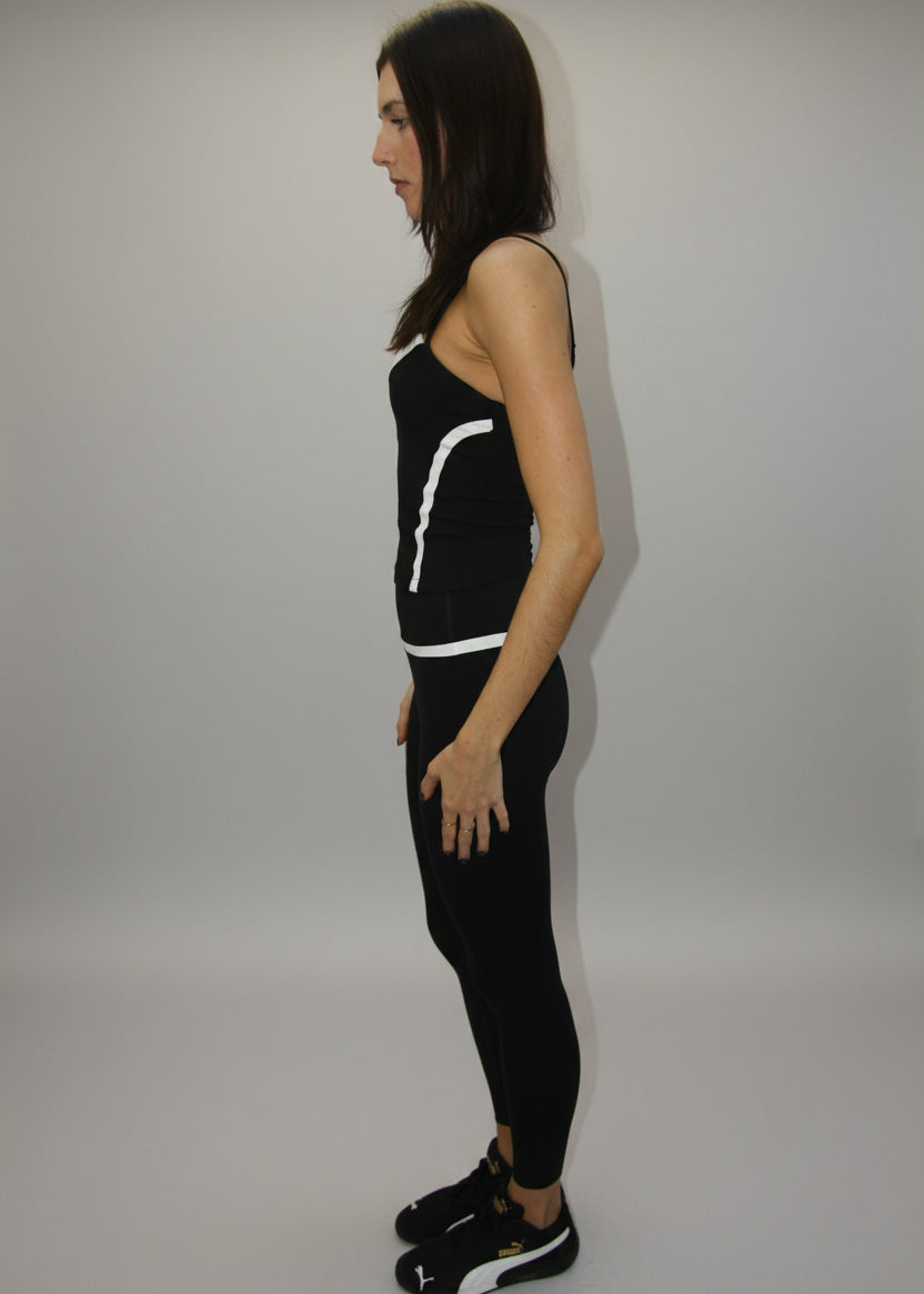 Woman lying on a white sheet with a black outfit