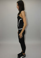 Woman lying on a white sheet with a black outfit